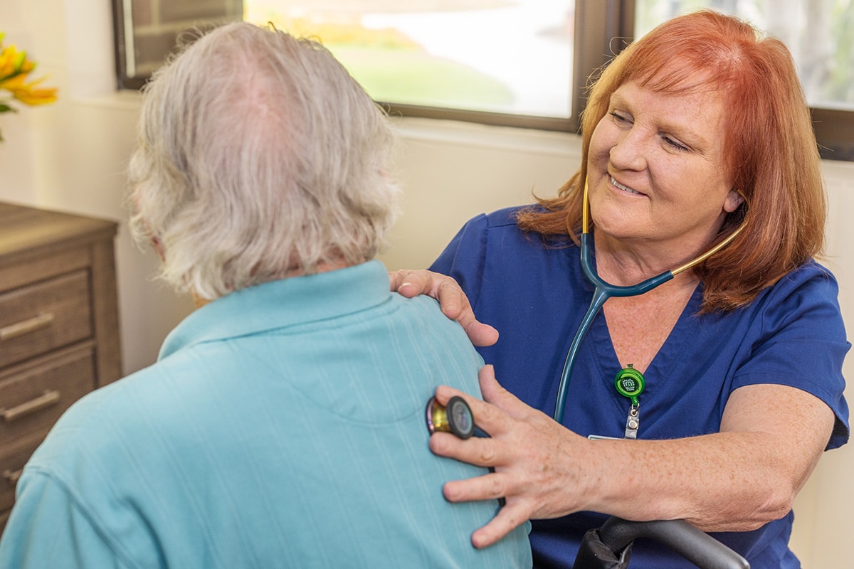 a nurse with a resident at Willow Creek facility