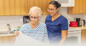 an occupational therapist and a resident in the kitchen